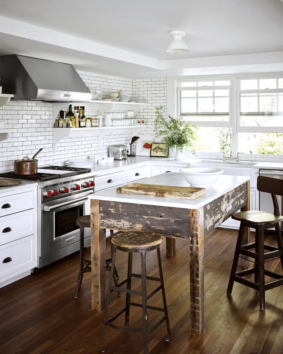 A renovated kitchen with modern appliances and rustic wooden elements