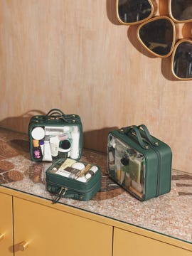a group of green suitcases on a counter