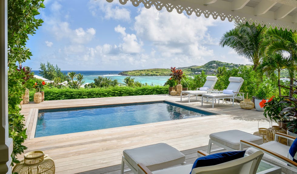Luxurious outdoor setting with a swimming pool and ocean view.
