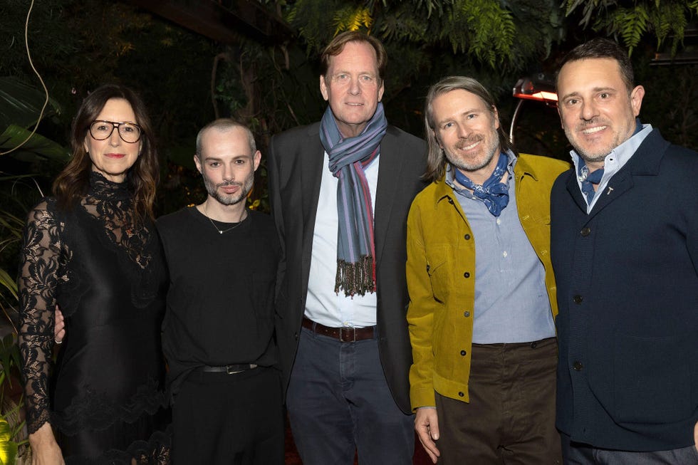 Group of individuals posing together in a social setting.