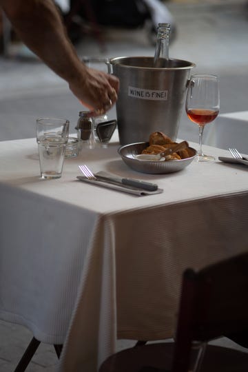 a person pouring a drink into a glass