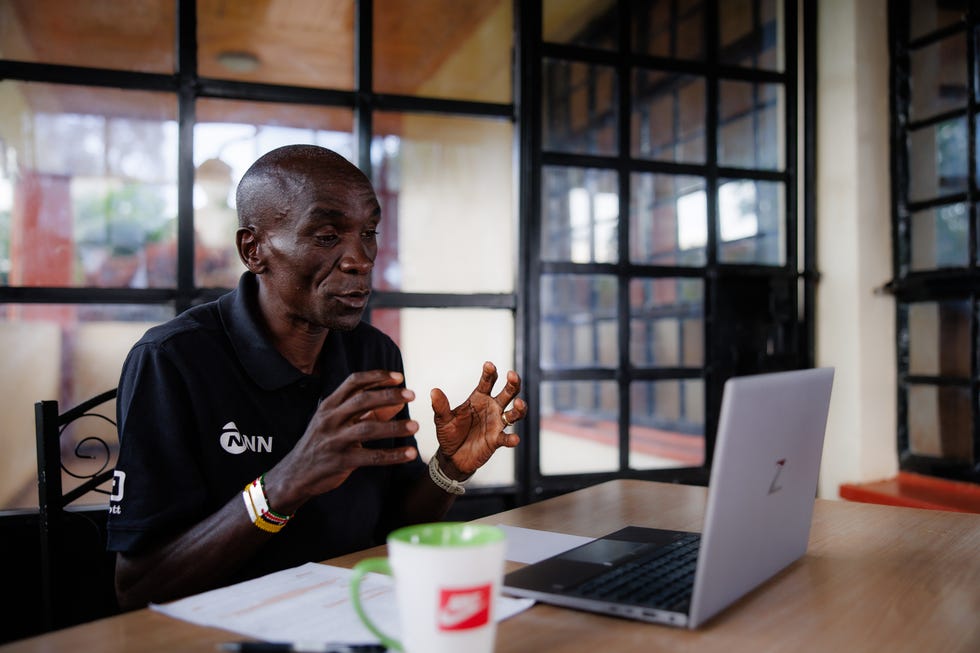 eliud kipchoge speaking to a laptop