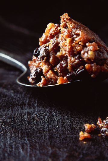 spoonful of christmas pudding on wooden surface