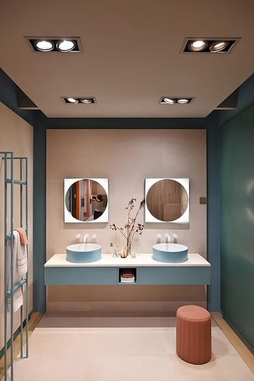 a bathroom with a large mirror at the cersaie event
