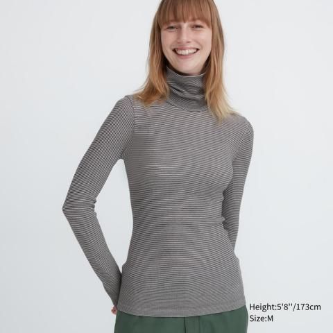 a woman wearing a grey sweater