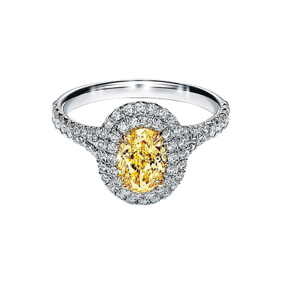 a diamond ring with a yellow gem