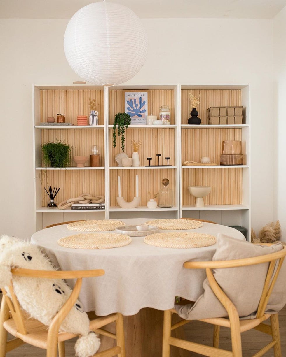 a dining room table with a white table and chairs