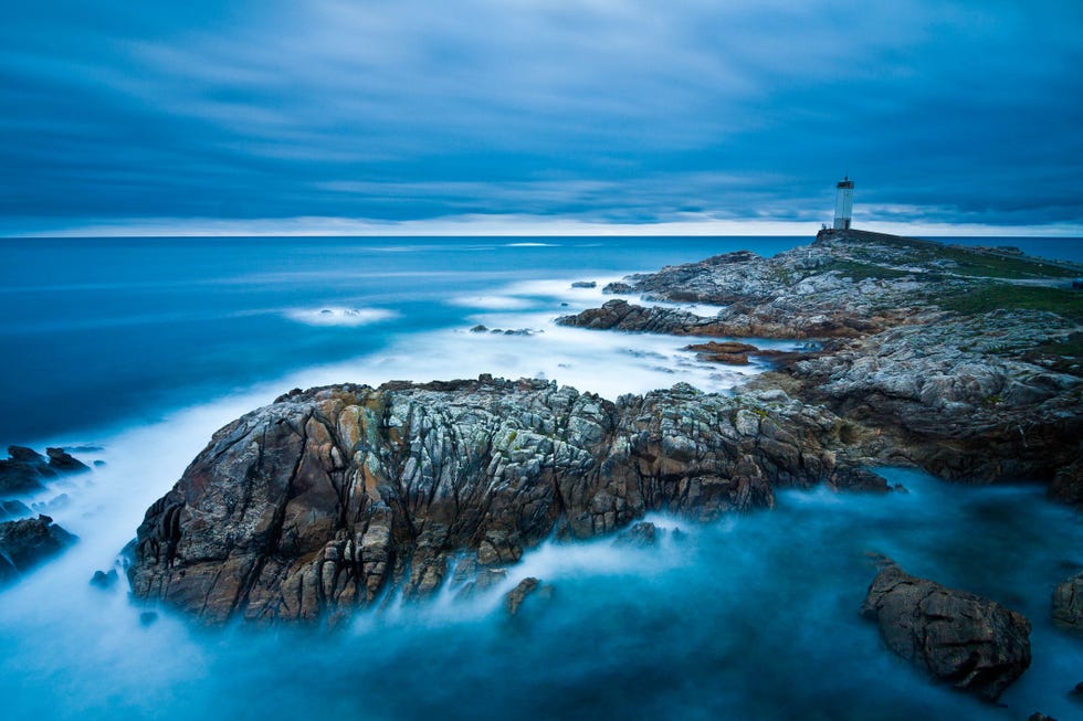 a lighthouse on a rocky island