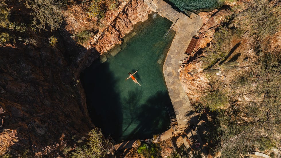 woman floating in outdoor hot spring