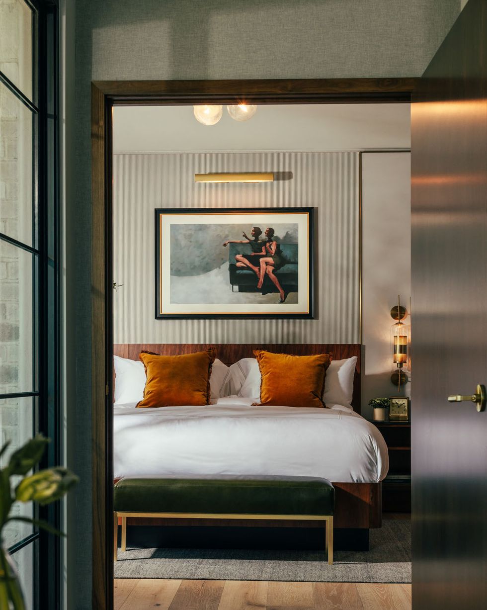 a bed with orange pillows