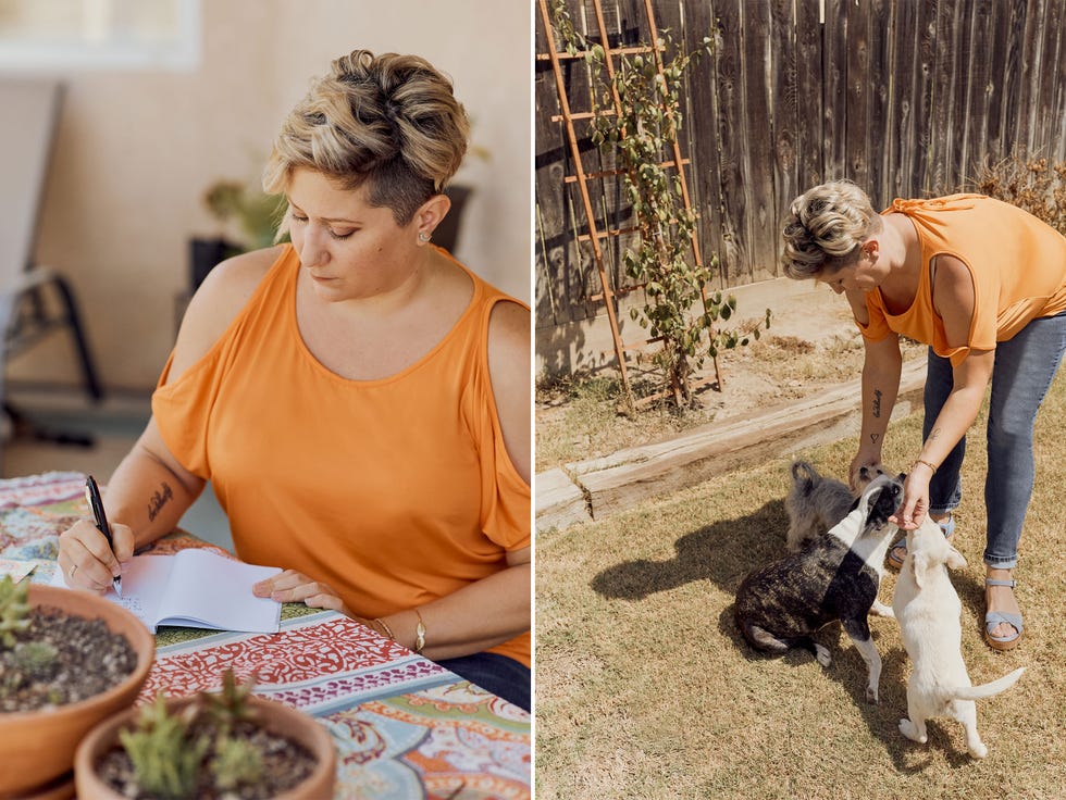 A woman petting her dog and writing