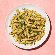 pasta with herbs on a pink background