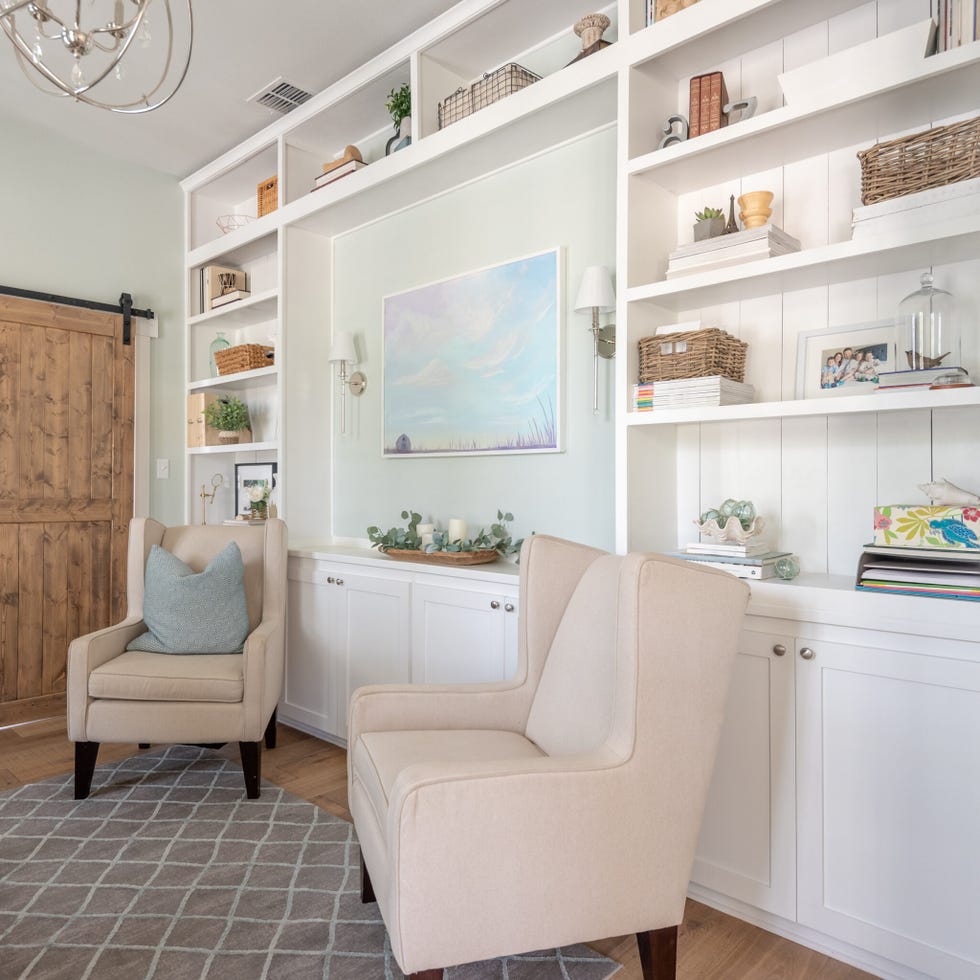 a white room with a white shelf and a chair