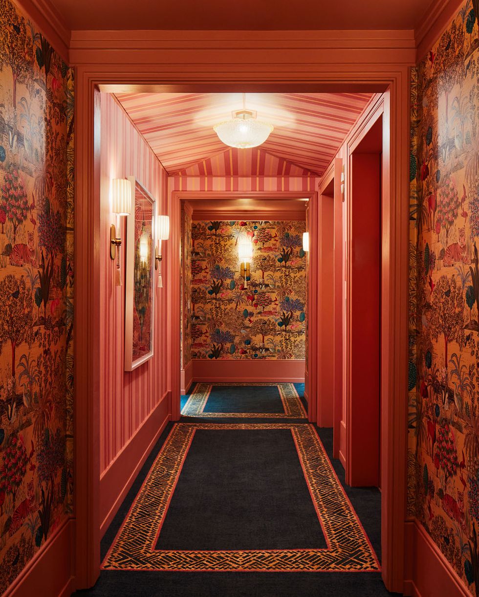 a hallway with a rug and flowers