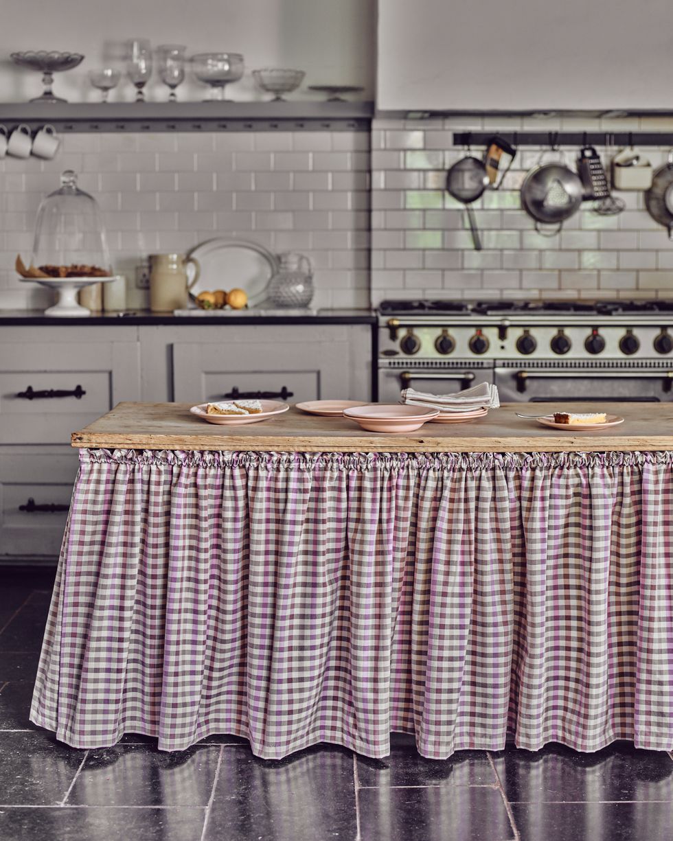 a kitchen island with check fabric skirt
