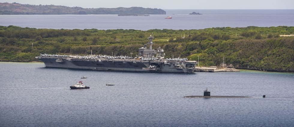 200515 n tc338 1832apra harbor, guam may 15, 2015 the los angeles class fast attack submarine uss topeka ssn 754 transits past the nimitz class aircraft carrier uss theodore roosevelt cvn 71 while moored pier side at naval base guam, may 15, 2020 topeka is one of four forward deployed submarines assigned to commander, submarine squadron 15 us navy photo by mass communication specialist 3rd class conner d blakereleased