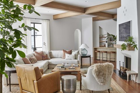 living room, white walls, wooden beams, white sofa, brown leather chair