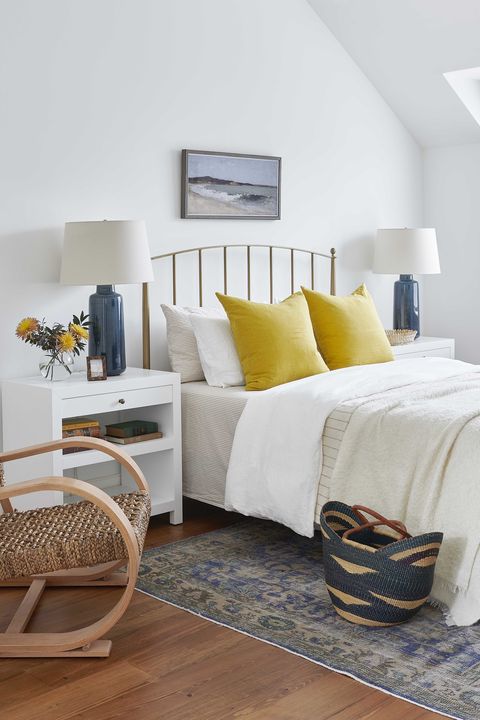 bedroom, white linen, gold headboard, yellow cushions, chair