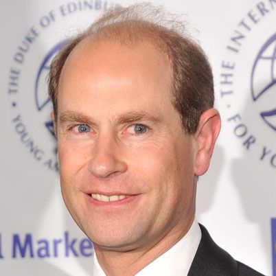 prince edward smiles toward the camer, he wears a suit jacket and white collared shirt