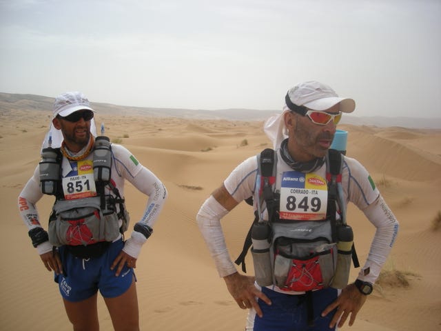 a couple of men wearing racing gear