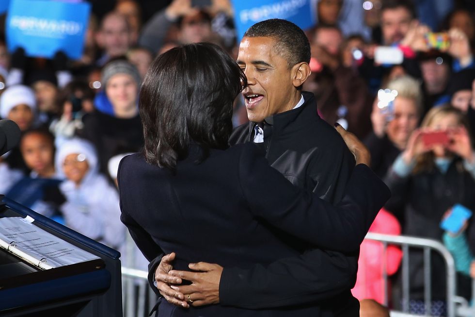 des moines, ia   november 05  us president barack obama embraces first lady michelle obama during his last rally the night before the general election november 5, 2012 in des moines, iowa the rally was held just outside obamas first headquarters from the 2008 campaign, where his first march to the white house started obama and his opponent, republican presidential nominee and former massachusetts gov mitt romney are stumping from one swing state to the next in a last minute rush to persuade undecided voters  photo by chip somodevillagetty images