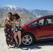music festival goers stop for a photo opp with their bolt ev at iconic indio, california stops