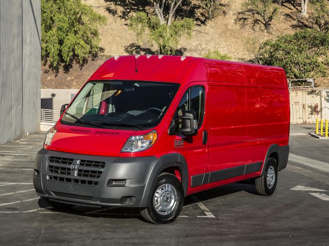 2017 red ram promaster parked outside warehouse