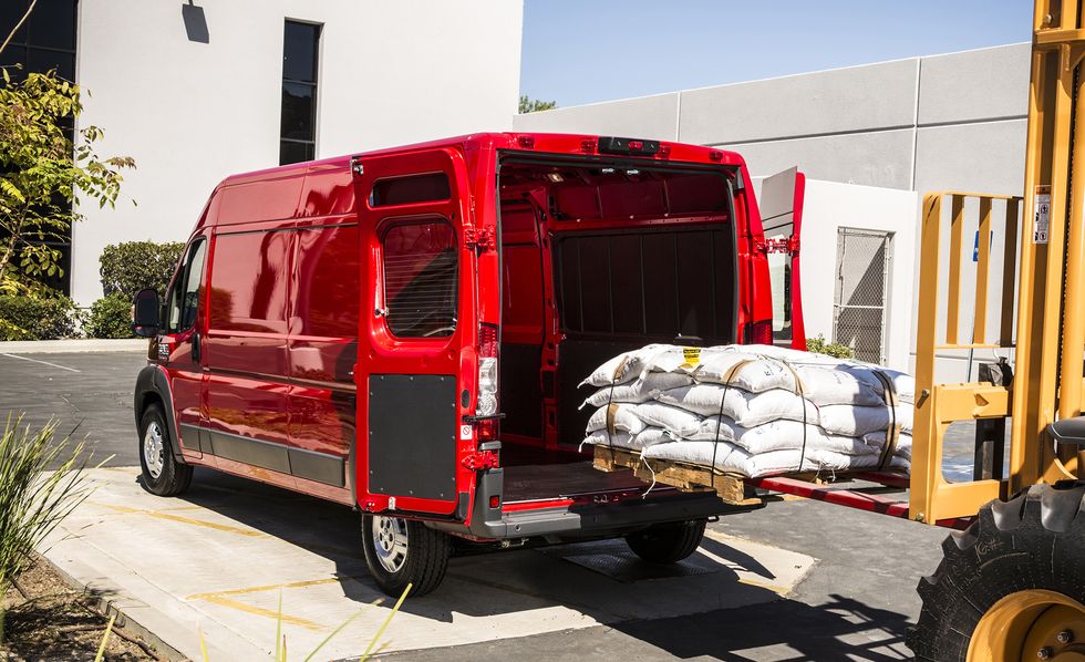 2017 red ram promaster van being loaded with a pallet of bags of soil