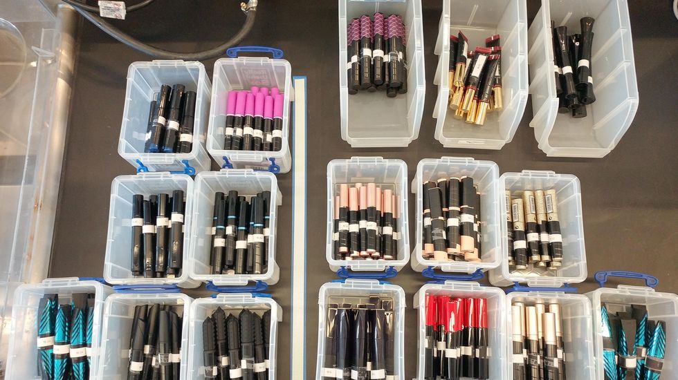 a collection of label blinded mascaras in bins within the good housekeeping institute beauty lab testing