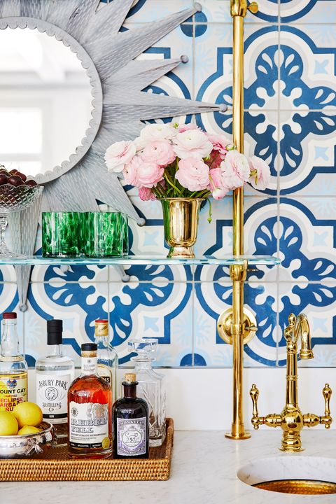 colleen bashaw bar with gold taps and blue and white mosaic tiles