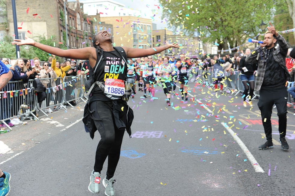 Participants celebrating in a marathon with confetti and cheering spectators