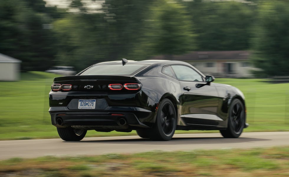 2019 chevrolet camaro driving past a farm