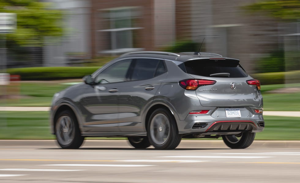 2023 buick encore gx driving down a city street