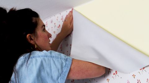 woman applying wallpaper