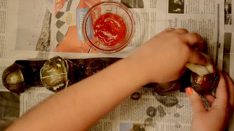hand rubbing tomato paste on bell
