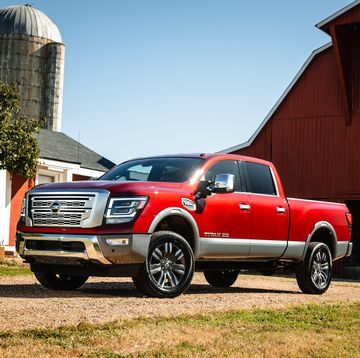 2023 nissan titan xd pickup in front of a barn and grain silo