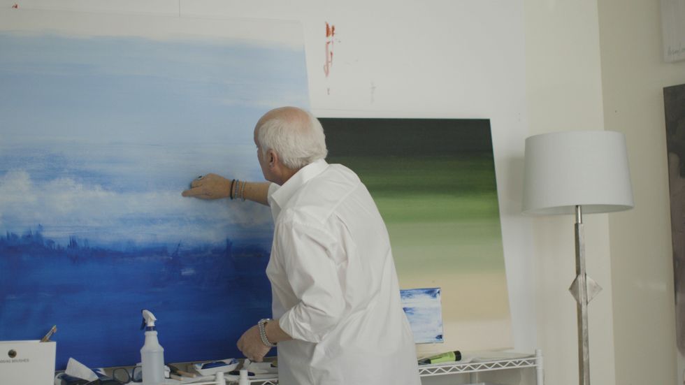 man painting a canvas
