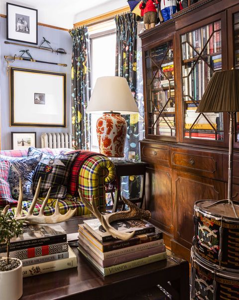 living room, wooden vintage coffee table, coffee table books, wooden dresser bookcase, tartan couch, large side lamp