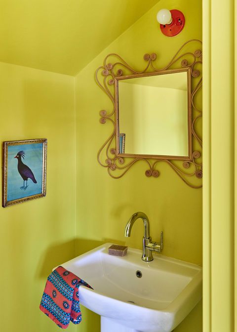 yellow powder room, yellow painted walls with a white basin, bird artwork