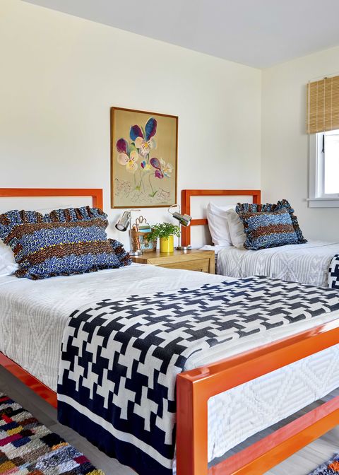 orange bed frames, twin beds, black and white throws