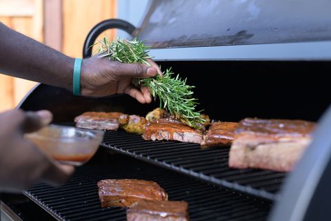 chef darryl bell rubs meat with rosemary sprig