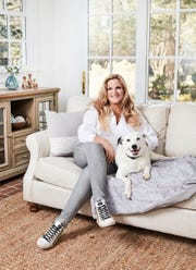 trisha yearwood sitting on a couch with her dog