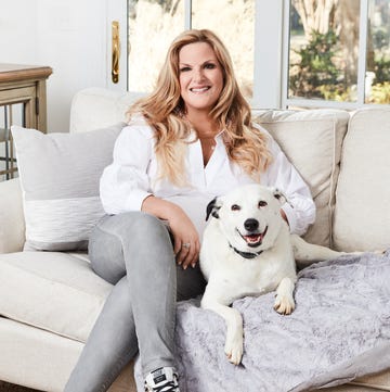 trisha yearwood sitting on a couch with her dog trisha yearwood sitting on a couch with her dog