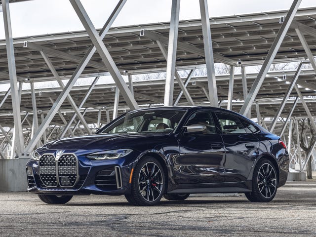 blue 2023 bmw 4series gran coupe parked underneath solar panels