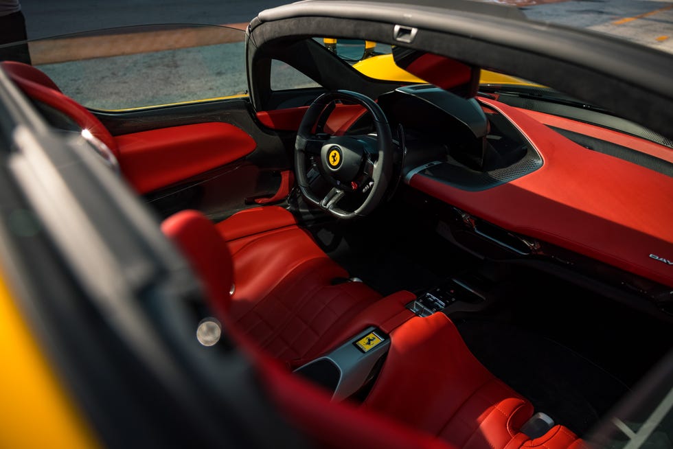 the interior dashboard of a yellow convertible