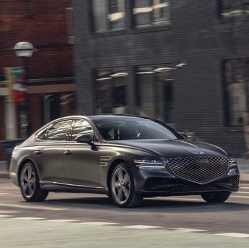 2023 genesis g80 sport driving through downtown