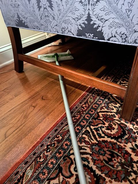 testing a swiffer mop under low furniture