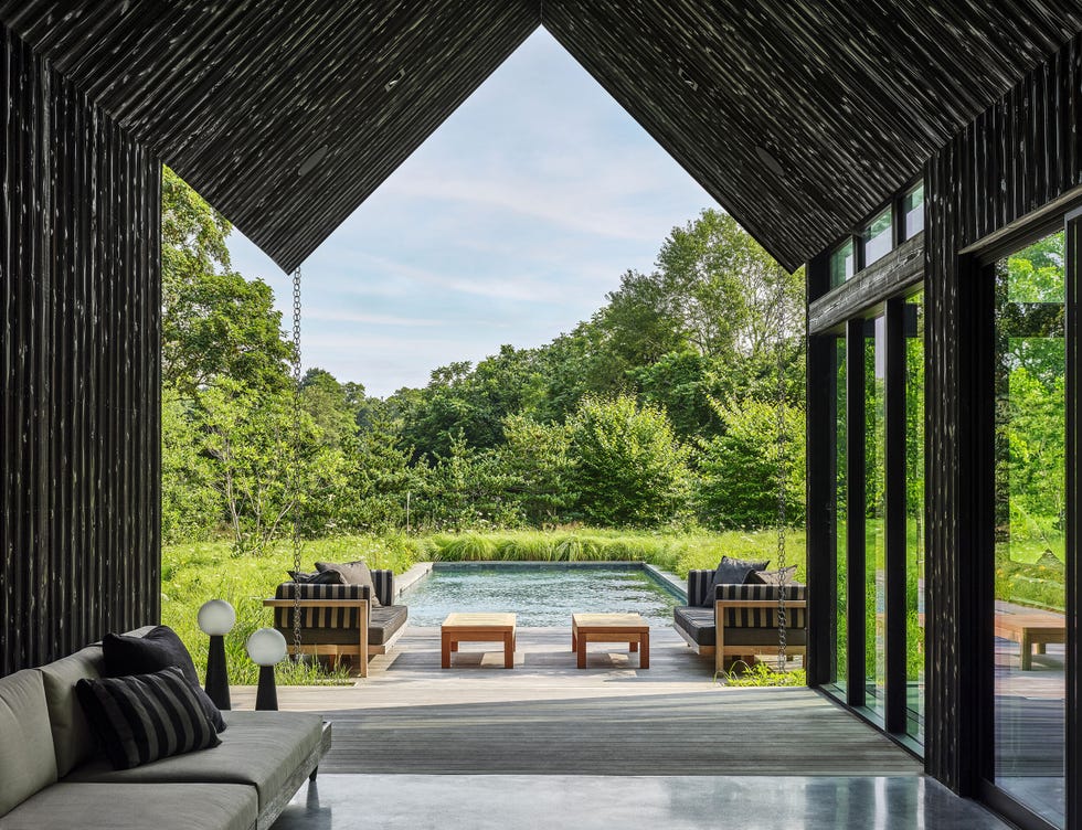 a patio with a pool and chairs a patio with a pool and chairs