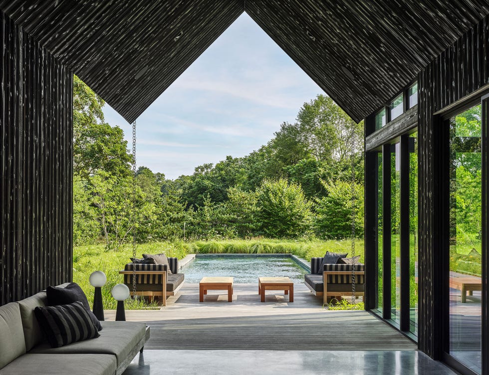 a patio with a pool and chairs