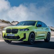 2023 bmw x4 m competition suv driving a coastal highway